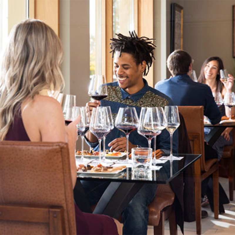 Couples enjoying wine in the Corner 103 tasting room